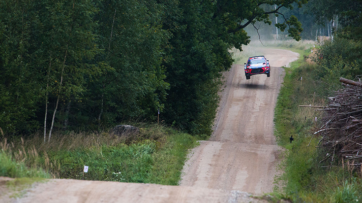 WRC rally car jumping on the road