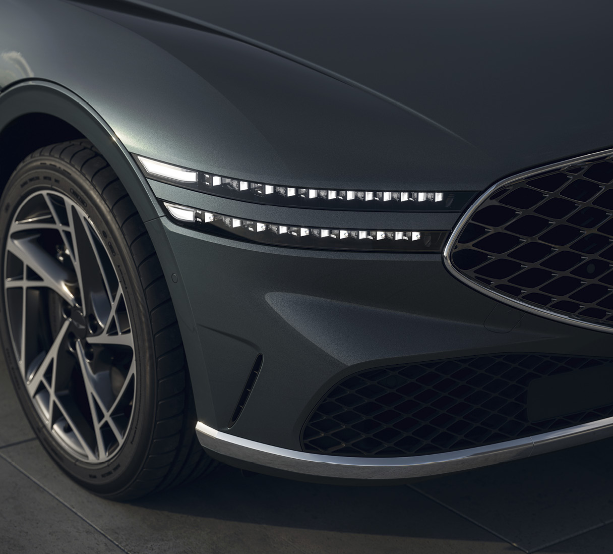 A close-up photo of the headlamps of the Genesis G90