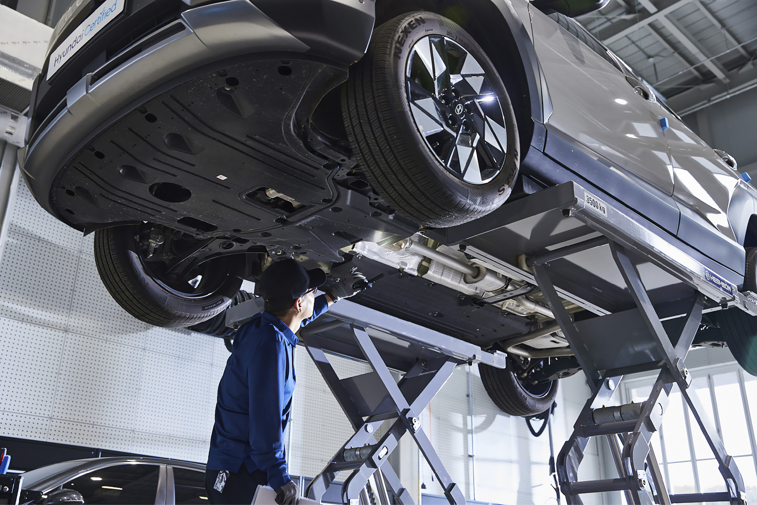 a car lifted into a maintenance lift