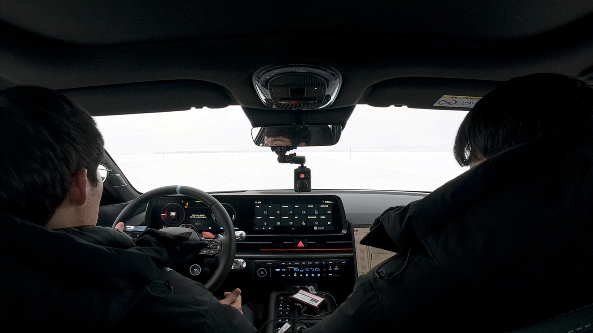 Engineers conducting a driving test inside the vehicle cabin