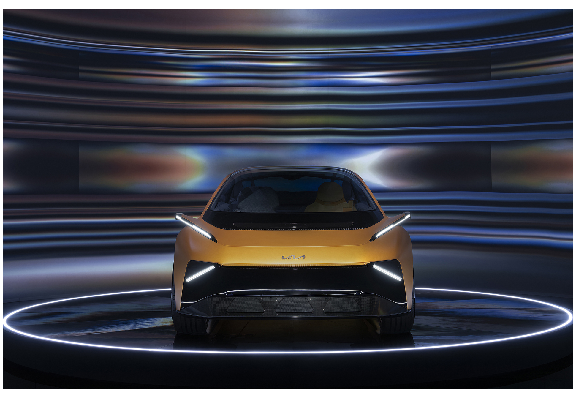 A front-facing vehicle image amid lighting effects expressing a sense of high speed