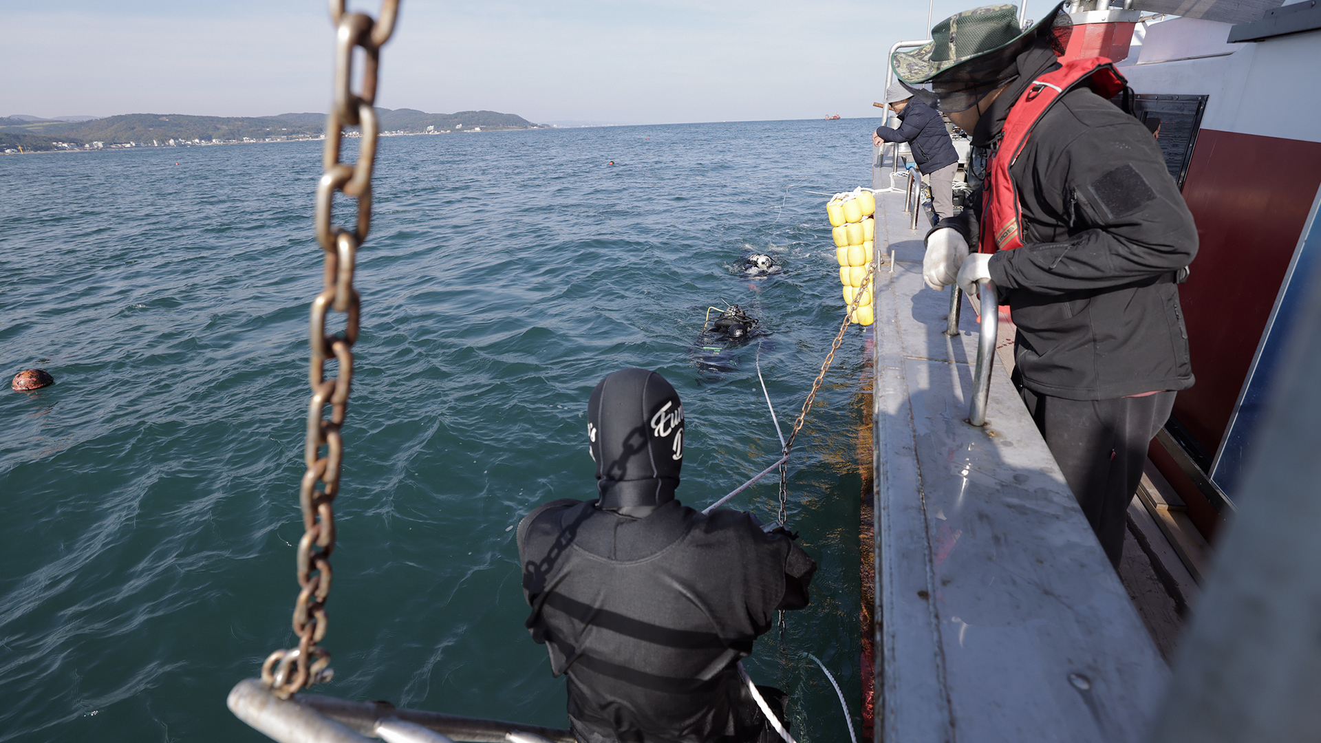 Researchers conducting sea forest restoration work from a vessel