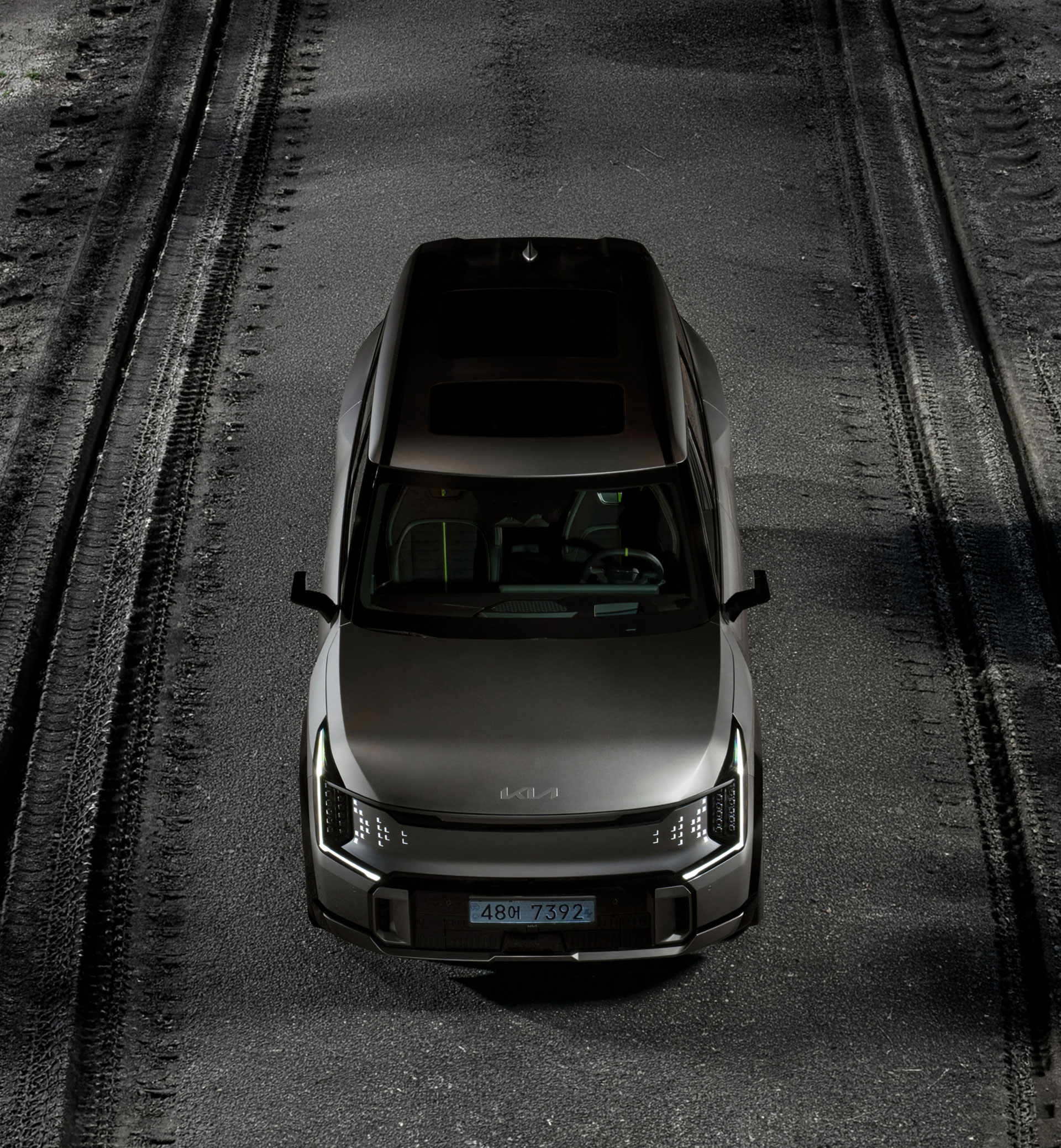A front overhead view of an EV9 GT vehicle on the road.