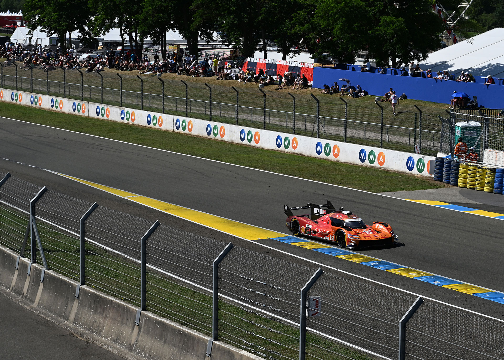 The GMR-001 #19 car racing on the circuit