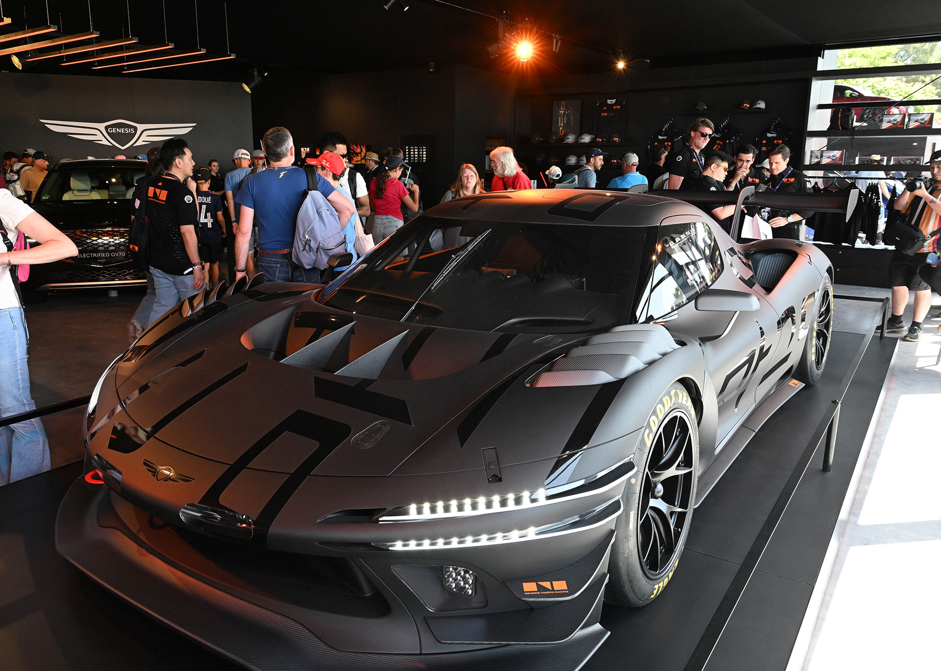 The front-side view of the displayed Magma GT3 vehicle.