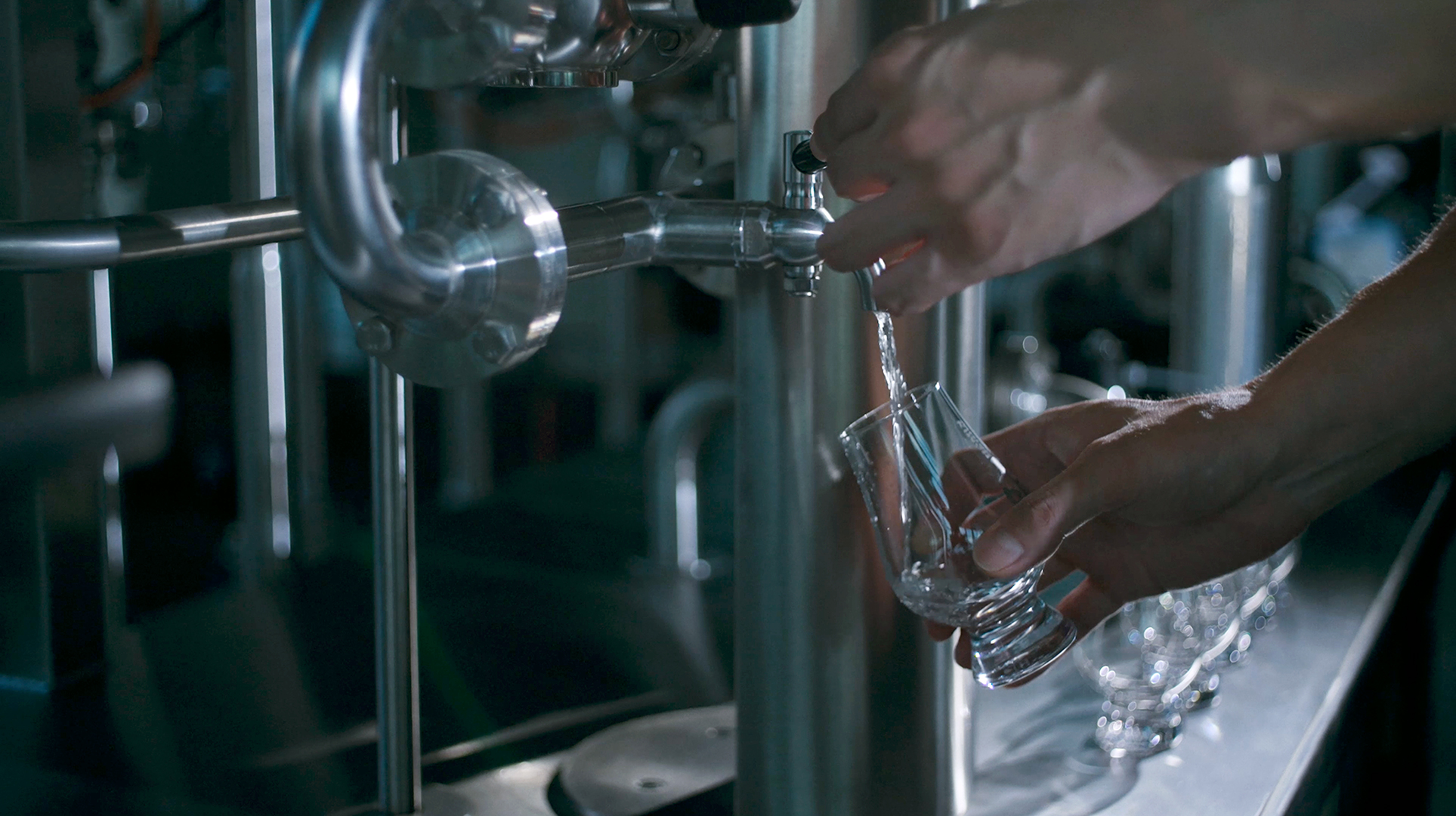 Pouring distilled whisky into a glass