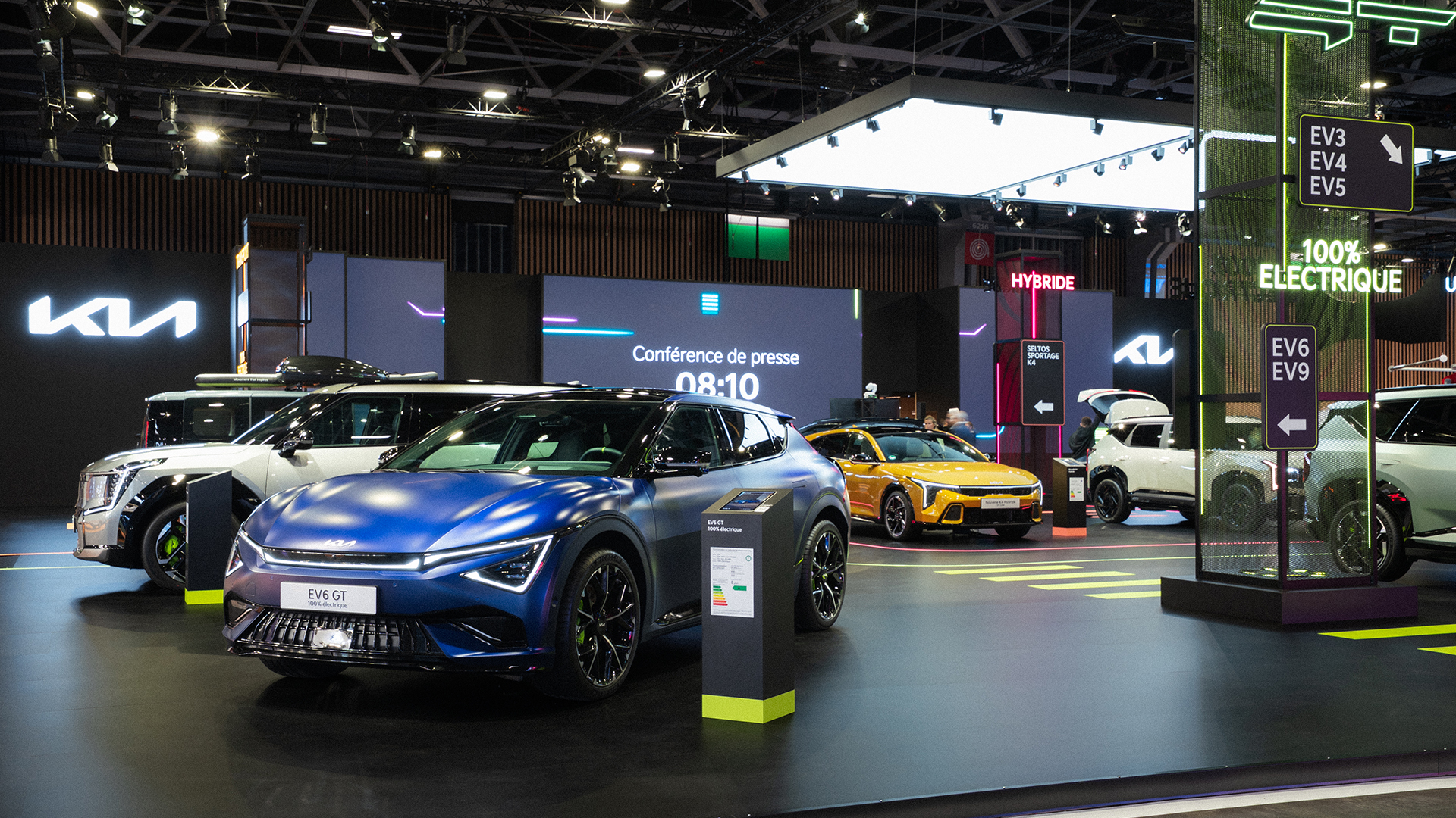 Kia auto show stand featuring matte blue EV6 GT and illuminated signage